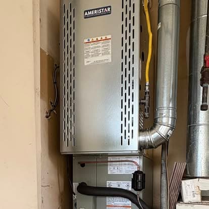 Ameristar heating and cooling unit installed in residential space with visible ductwork.
